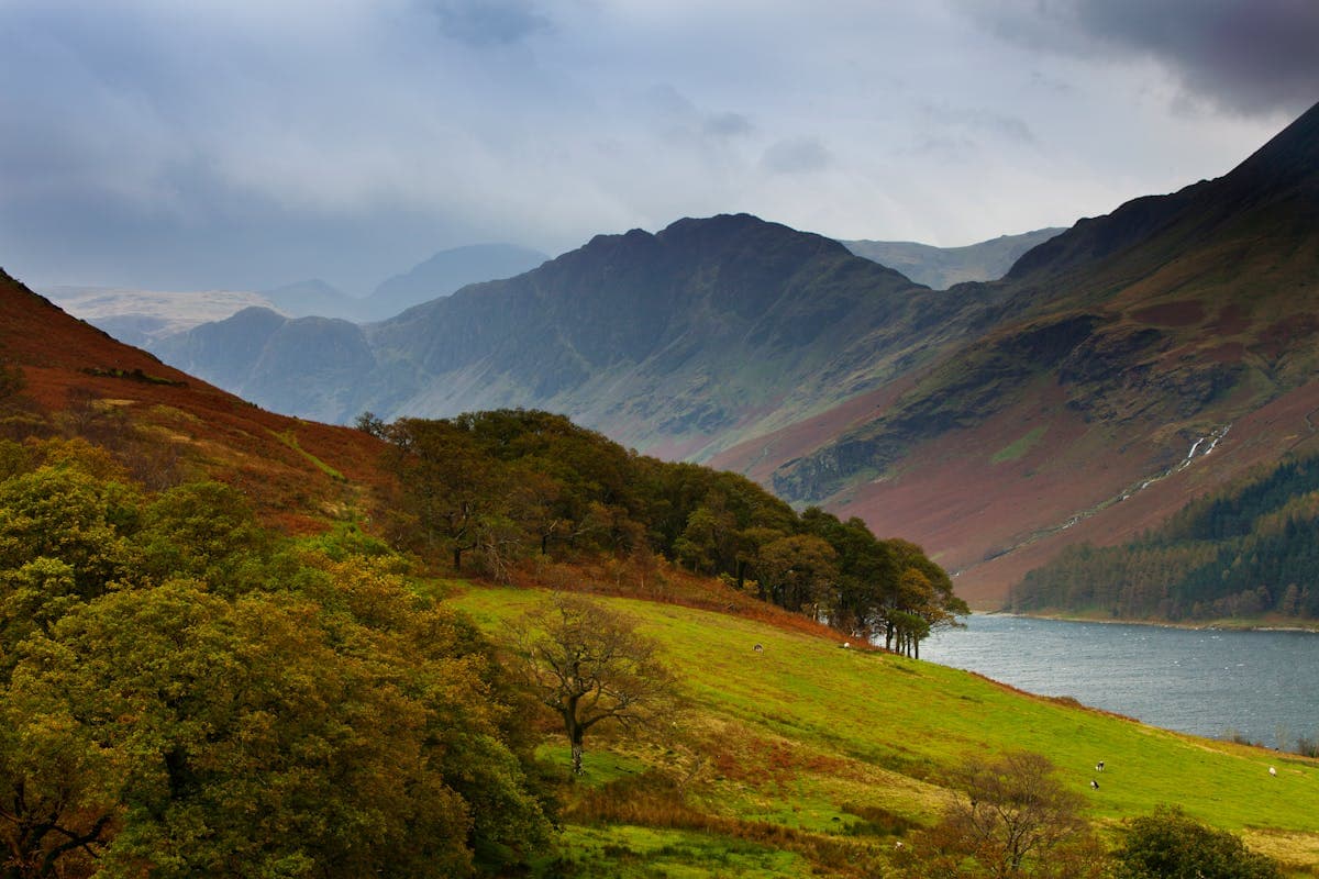 Sunrise over Ullswater, still water reflecting the fell above in perfect light