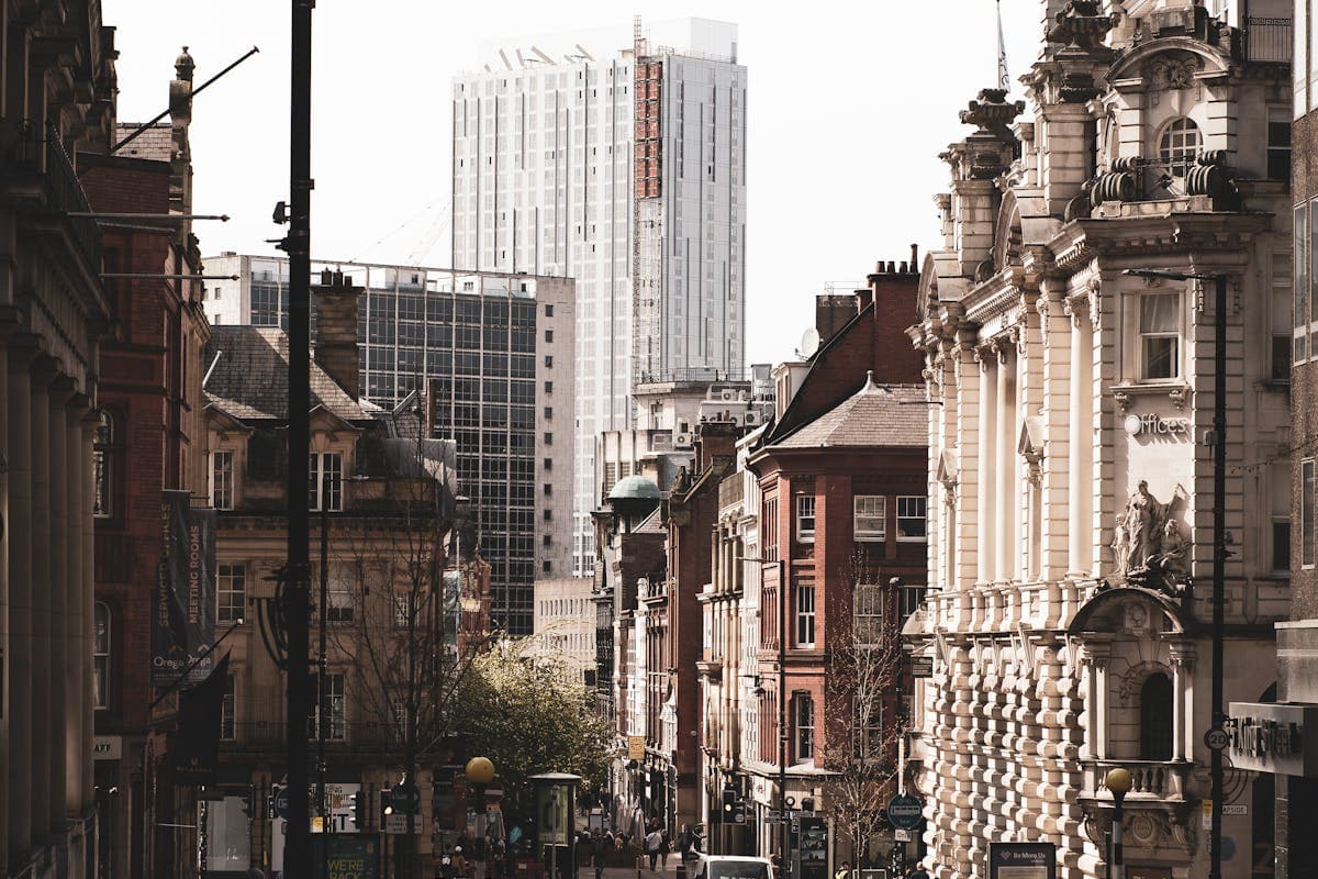 The Northern Quarter at dusk, red brick buildings lit by warm street lights